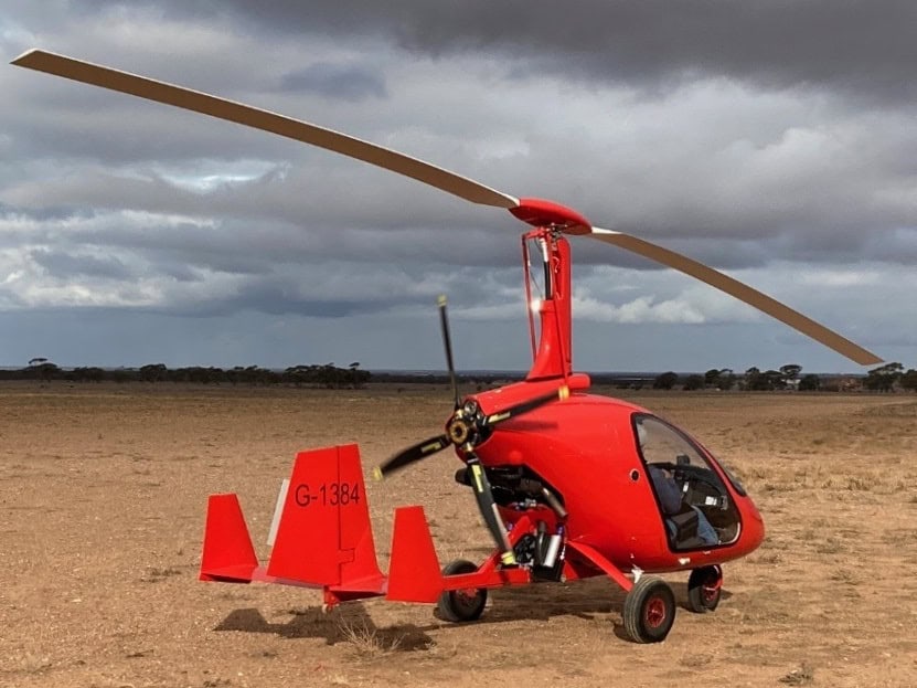 Enclosed gyro parked with storm clouds